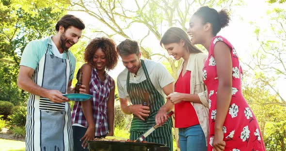 Man serving barbecue to his friends