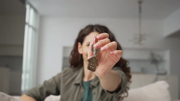 Happy Woman Showing Keys to New House Closeup
