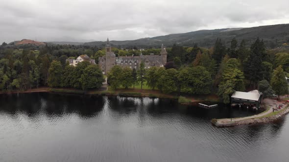 Slow descend over Loch Ness facing Fort Augustus Abbey, aeria