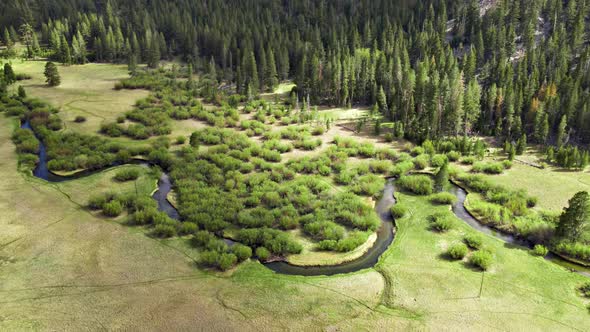 Aerial Of A Winding River Through A Meadow