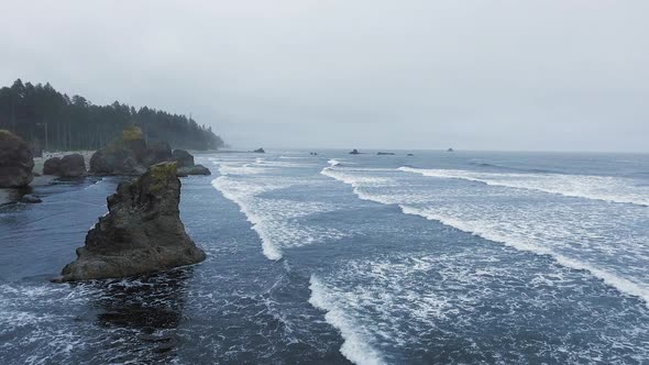 Aerial shot of ocean waves breaking on rocks at Ruby Beach, Olympic National Park, Washington, USA