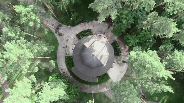 Beautiful christian domed church in green trees in city park at sunny day, top drone view alt