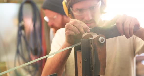 Bladesmith deburring a blade on belt grinder