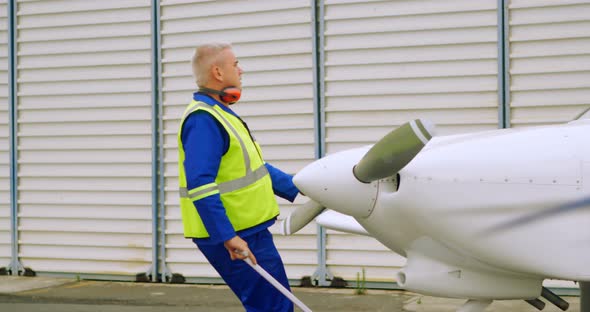 Male engineer pulling an aircraft