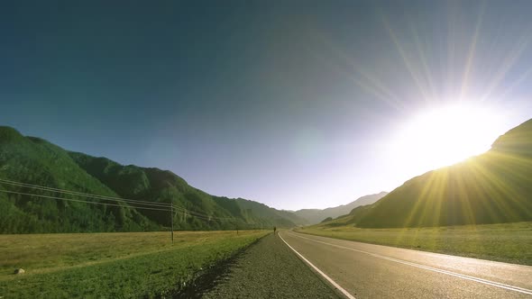 Mountain Road Timelapse at the Summer or Autumn Sunset Sunrise Time. Wild Nature and Rural Field.