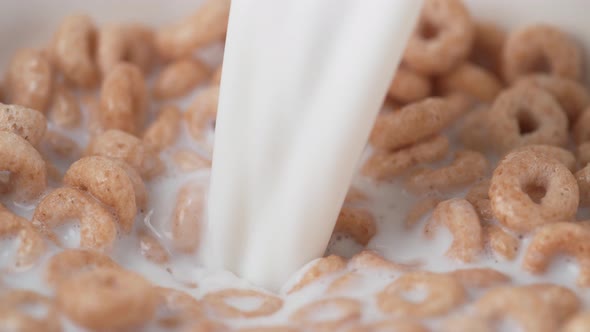 Pouring milk into cereal. Slow Motion.