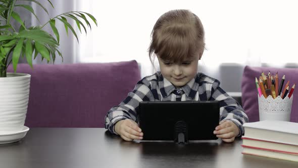 Girl Studying Online Homework Using Digital Tablet Computer. Distance Education