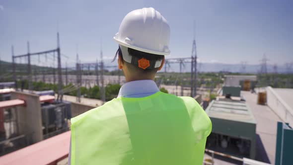 Engineer speaking by radio at power station.