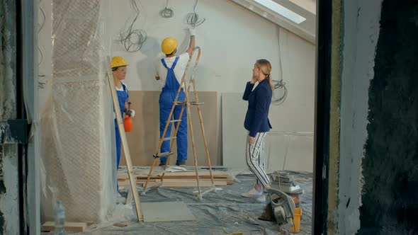 Woman on a Call with Contractors Discussing at Construction Site