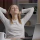 Young good looking caucasian girl stretching and smiling while sitting at the kitchen table - VideoHive Item for Sale