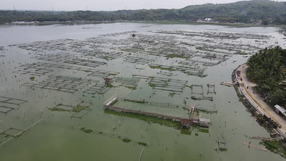 Aerial view of traditional floating fish pond on swamp in Indonesia