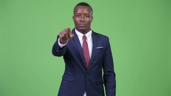 Young African Businessman Pointing To Camera