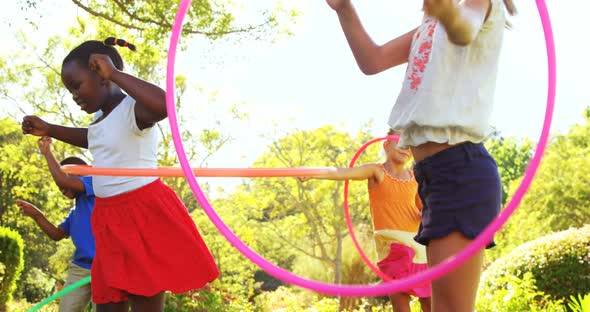 Group of kids twirling hula hoop