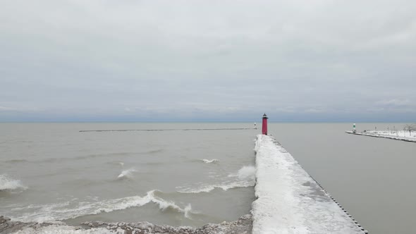 Lake Michigan landscape on a cold, cloudy, gray winter day with lighthouse.