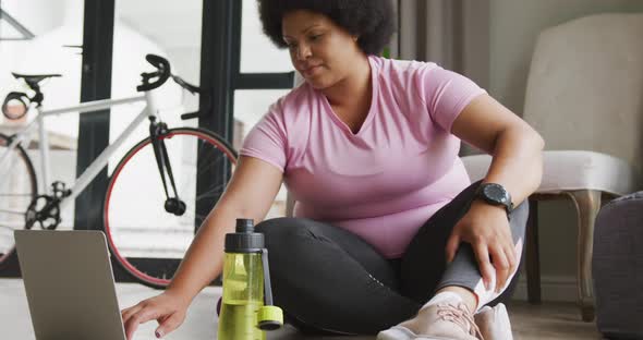 Video of midsection of plus size african american woman in sport clothes preparing for exercising