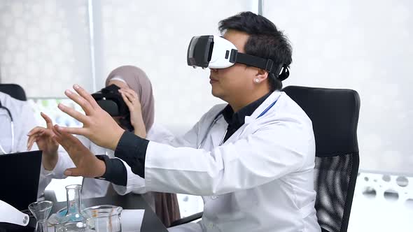 Asian Young Male and Muslim Female Medical Workers which Wearing Virtual Reality