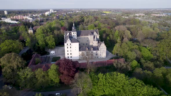 Flying out from the side of Wolfsburg castle surrounded by forest