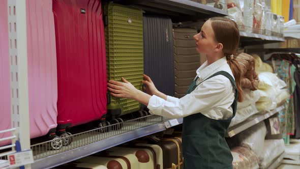 Redhaired Buyer Chooses Stylish Suitcase for Travel Closeup