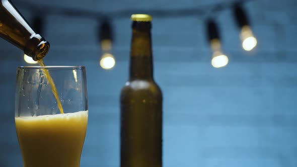 Red beer pouring into a glass