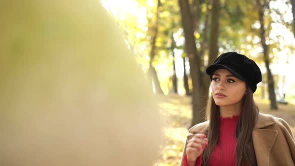 Thoughtful Girl in Stylish Clothes Posing and Looking Around in Autumn Park