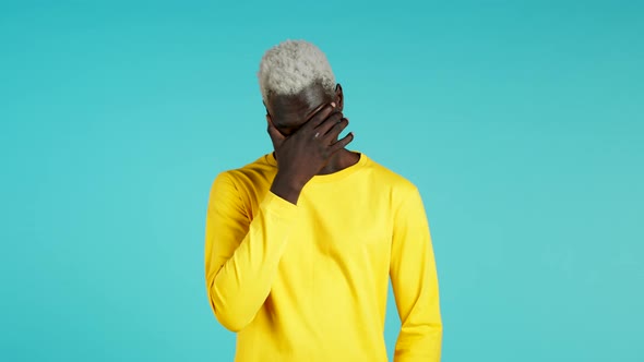 Young African Guy Covers His Face with Hands From Fatal Disappointment, Failure. Depressed Lost Man