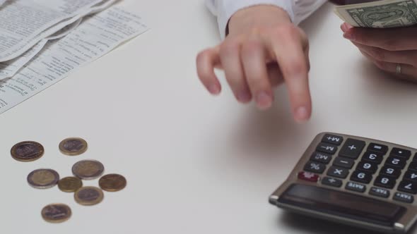 A Man Considers the Budget on a Calculator