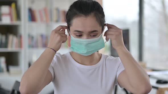 Portrait of Cautious Young Woman Wearing Face Mask 