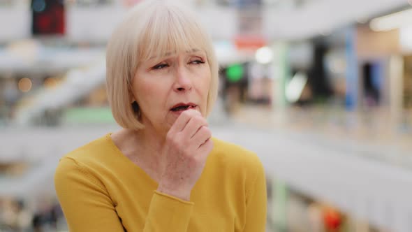 Mature Caucasian Unwell Woman Standing Indoors Coughing Covers Mouth with Hands Elderly Unhealthy
