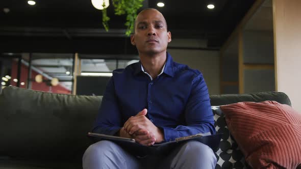 Mixed race businessman having video chat listening and nodding in office