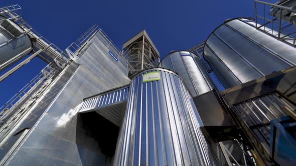 Metallic warehouse outdoors. Large aluminium containers against blue sky. 