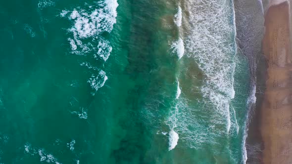 Aerial View of the Mediterranean Coast Waves Reach the Deserted Sandy Beach