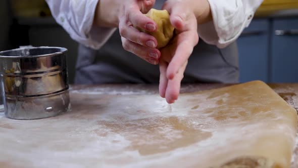 The Pastry Chef Kneads the Dough in His Hands Then Wipes It with Flour Puts It on Parchment and