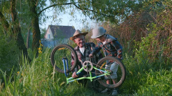 Family Weekend, Handsome Grandfather with Beautiful Grandson in Napper Have Fun and Checks Pedals