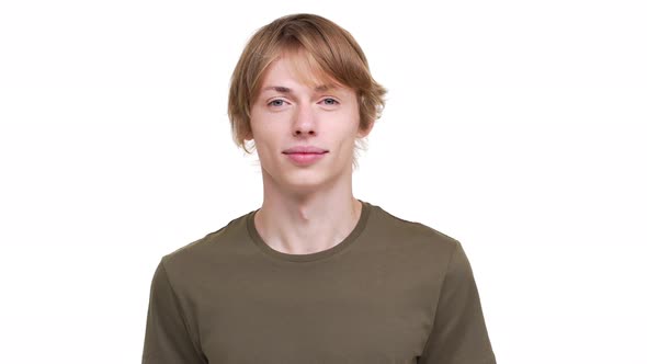 Portrait of Joyous Man in Green Tshirt Nodding in Agreement Looking on Camera with Smile Meaning Yes