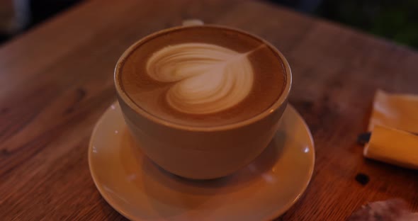 White Cup with Cappuccino Coffee for Breakfast on White Wooden Background in Modern Cafe