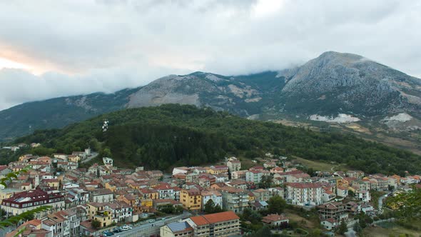 Timelapse of a cloudy mountain landscape in a little town in South Italy at dusk