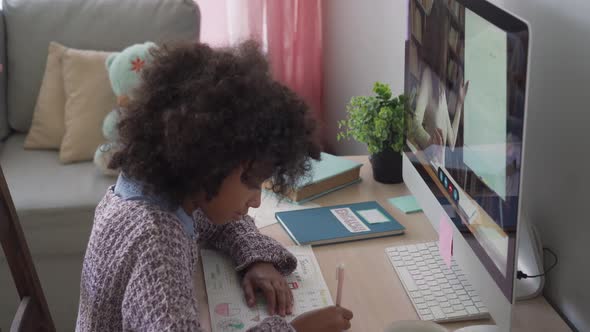 African School Kid Girl Online Learning with Remote Teacher at Home on Computer