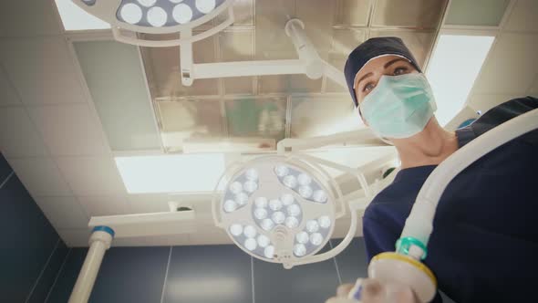 Low angle view of young anesthesiologist at work