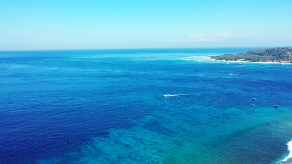 Aerial nature of tranquil coastline beach wildlife by blue ocean and white sand background of advent