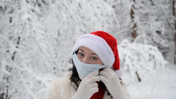 Christmas Winter Portrait of a Beautiful Girl Wearing a Protective Mask on Her Face To Protect