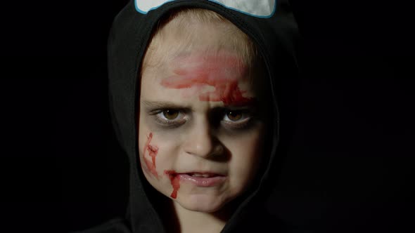 Halloween, Angry Girl with Blood Makeup on Face. Kid Dressed As Scary Skeleton, Posing, Making Faces