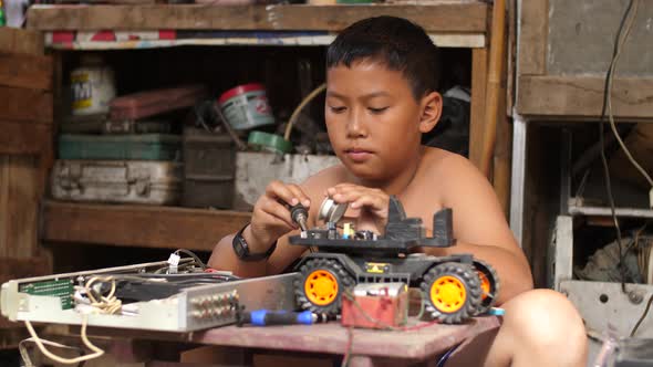 Asian Boy Creating Robotics Project