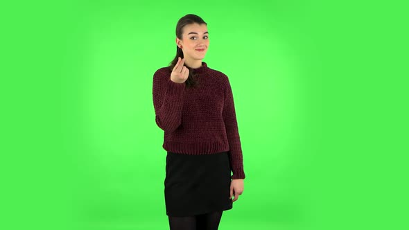 Cute Girl Smiles and Showing Heart with Fingers. Green Screen