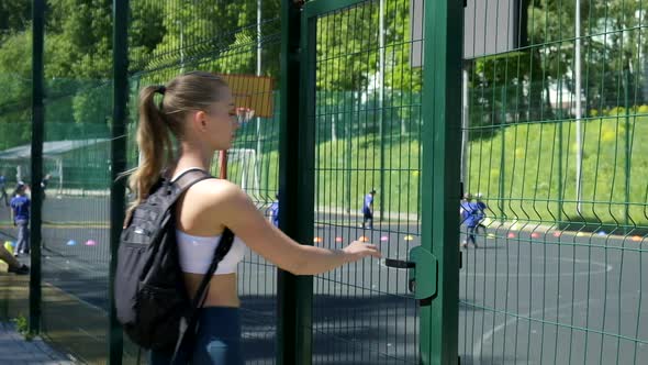 Young Fit Athletic Blond Girl with Ponytail in Sportswear Entering Sports Ground