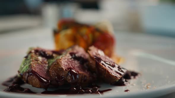 Filet mignon and ratatouille on a plate serving a dish in a restaurant