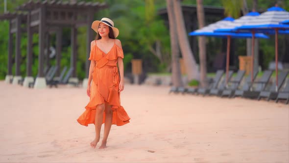 Asian woman enjoy around beautiful beach sea ocean