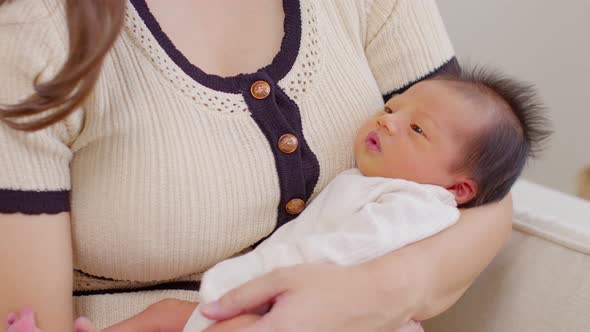 Adorable sleeping newborn baby relax in mother arm safety and comfortable