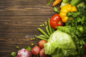 Assortment of fresh vegetables on wooden table background. Healthy organic food