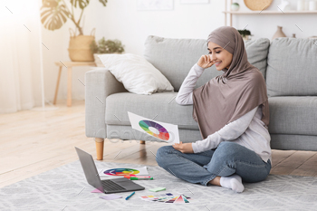  Hijab Holding Colour Gamma Palette And Working On Laptop At Home