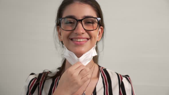 Young Woman Take Off Face Mask Removing From Face